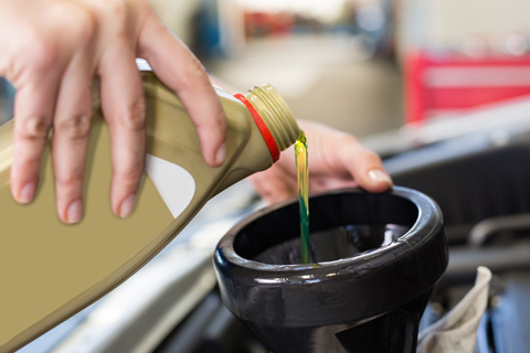 Image of Mechanic Pouring Oil Into Engine